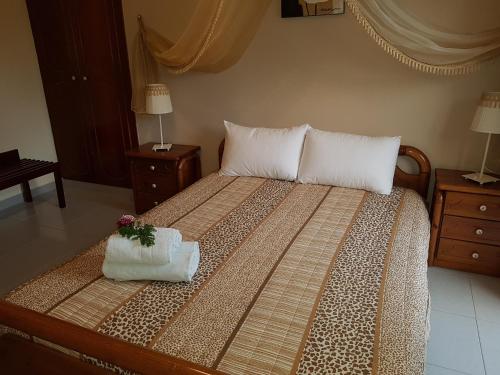 a bed with a white comforter and pillows at Georgia Old Town Apartments in Rhodes Town