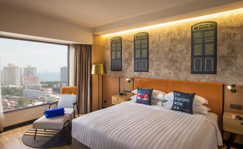 a bedroom with a large bed and a large window at JEN Penang Georgetown by Shangri-La in George Town