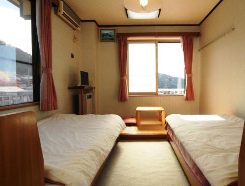 سرير أو أسرّة في غرفة في Villa Katashio