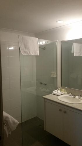 a bathroom with a glass shower and a sink at Ringwood Lake Inn in Ringwood