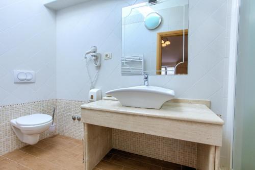 a bathroom with a sink and a toilet at Hotel Villa Margaret in Malinska