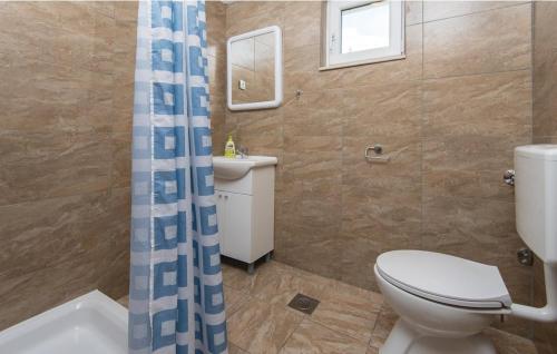a bathroom with a toilet and a shower curtain at Apartment Andrea in Orebić
