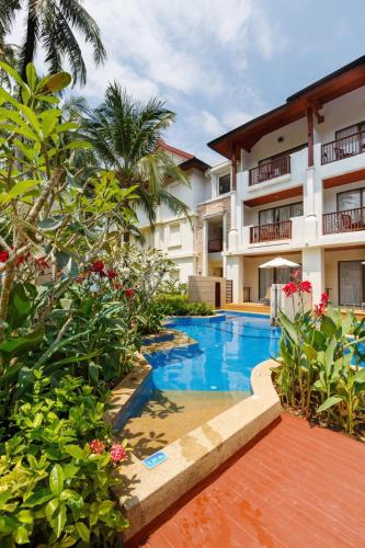a swimming pool in front of a building at Apsara Beachfront Resort & Villa in Khao Lak