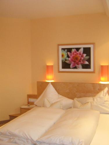a bedroom with a bed with a picture on the wall at Alt Mösern in Seefeld in Tirol
