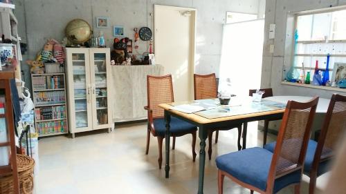 a dining room with a table and chairs at Guesthouse Seaglass in Itoman