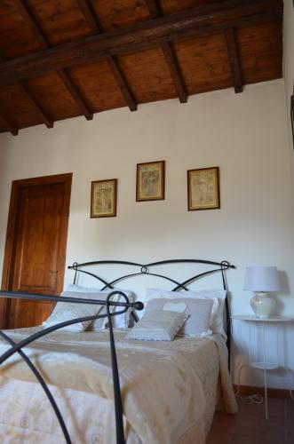 a bedroom with a bed and a wooden ceiling at Casa Sorgente in Montefiascone