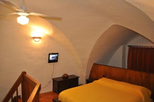 a bedroom with a bed and a ceiling fan at Le Casette di Via Roma in Nardò