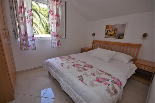 a bedroom with a bed and a window at Nikic Apartments in Herceg-Novi