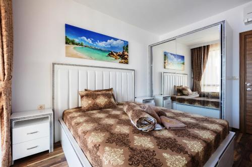 a bedroom with a bed with a large mirror at Boutique Apart Hotel Versis in Sunny Beach