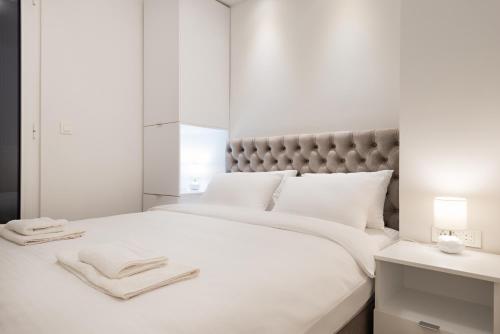 מיטה או מיטות בחדר ב-Vivio Luxury Apartment