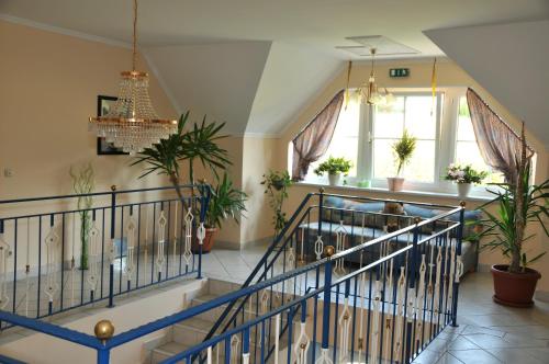 a staircase in a house with potted plants at Pension Thermensonne in Jennersdorf