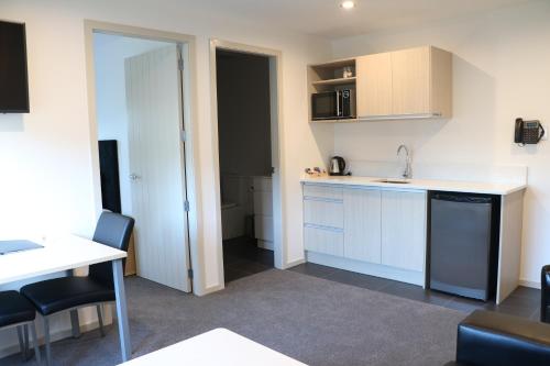 a kitchen with a sink and a counter top at MCM Motel Christchurch in Christchurch
