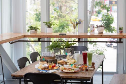 a wooden table with plates of food on it at Hotel Mapp in Taichung