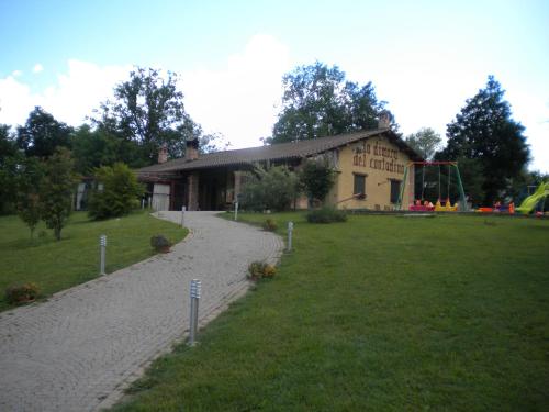 a building with a playground in front of a yard at Agriturismo La Dimora Del Contadino in Mondovì