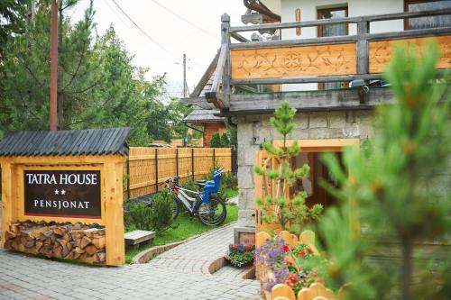 a sign for a tea house in front of a house at Tatra House Residence in Zakopane