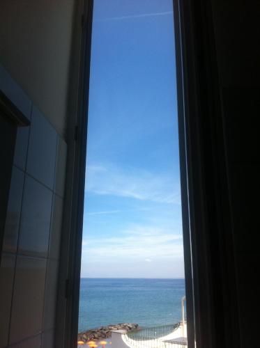 a view of the ocean from a window at Excelsior Mare Suite in Ischia