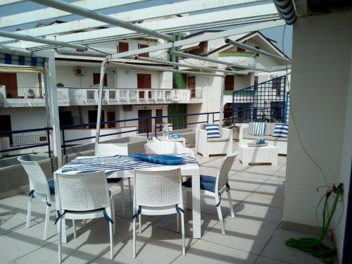a patio with a table and chairs on a balcony at Ipanema Suite in Giardini Naxos