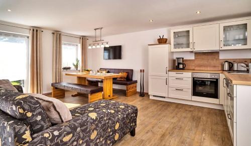 a kitchen and living room with a couch and a table at Ferienhof Stetter in Schöllnach