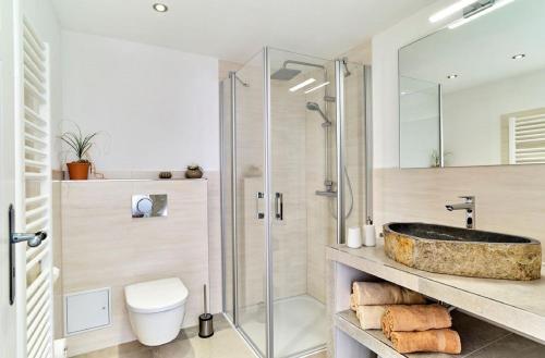 a bathroom with a glass shower and a sink at Ferienhof Stetter in Schöllnach
