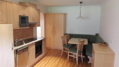 a kitchen with a table and chairs and a kitchen with a sink at Urlaub am Bauernhof Rothof in Sankt Johann im Pongau
