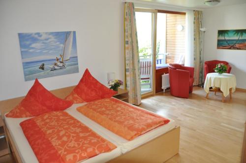 a bedroom with a bed and a living room with a table at Apart Hotel Stadtgarten in Überlingen