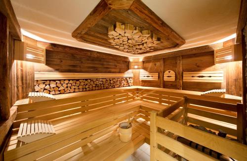 an empty sauna with wooden walls and wooden floors at Hotel Zehnerkar & Hotel Obertauern in Obertauern