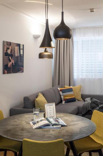 a living room with a table and a couch at RAFAEL KAISER - Premium Apartments City Centre - Contactless Check-In in Vienna