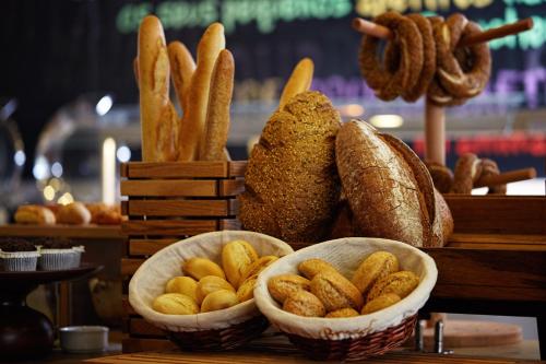 two baskets filled with bread and some types of food at Ibis Istanbul Tuzla Hotel in Tuzla