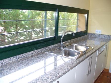 a kitchen counter with a sink and a window at Villa Torremirona Resort Palmeras in Navata