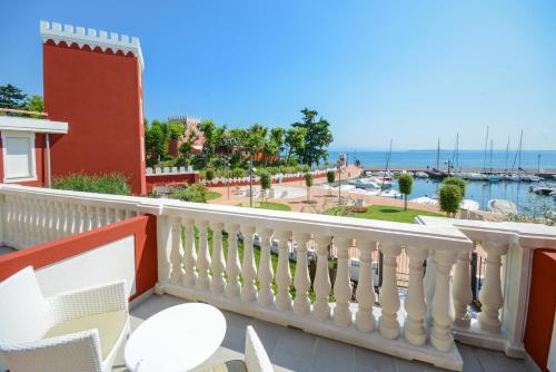 a balcony with a white railing and a view of the ocean at Hotel Villa Garuti in Padenghe sul Garda