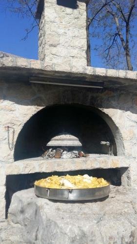 a stone oven with a pizza inside of it at Apartman Studio Zdravko Eco Village in Imotski