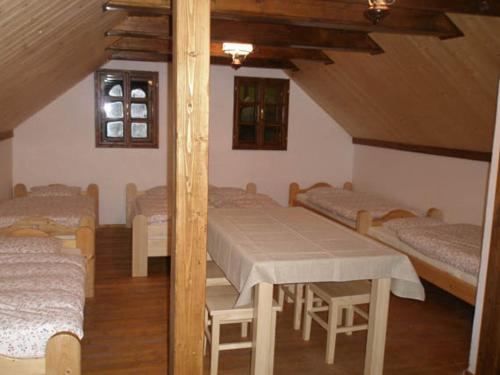 a attic room with four beds and a table at Vinarstvi Radim Mildner in Podivín