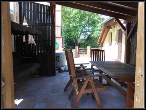 a patio with a wooden table and a wooden bench at Vinarstvi Radim Mildner in Podivín