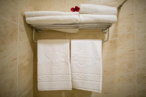a group of towels on a rack in a bathroom at Boutique Hotel Deluxe in Kamianets-Podilskyi