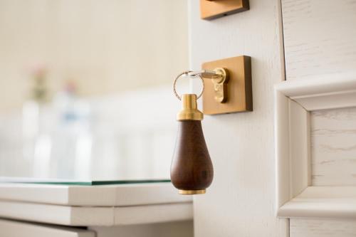 a bottle is hanging on a door knob at Boutique Hotel Deluxe in Kamianets-Podilskyi