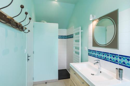 a bathroom with a sink and a mirror at Odorico by Cocoonr in Rennes