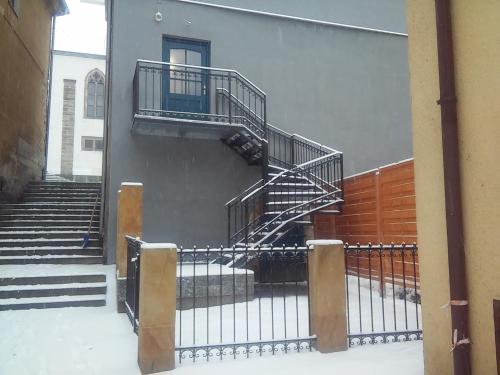 a staircase on the side of a building in the snow at Apartment Jakubske Namesti in Česká Kamenice