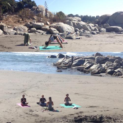 a group of people sitting on surfboards on a beach at La Ritoqueña Hotel de Playa in Concón
