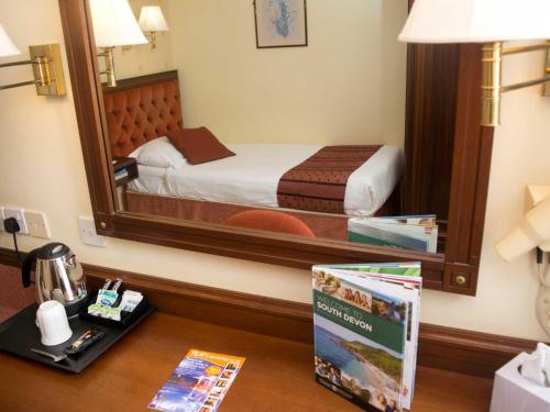 a hotel room with a bed and a mirror at TLH Toorak Hotel - TLH Leisure, Entertainment and Spa Resort in Torquay