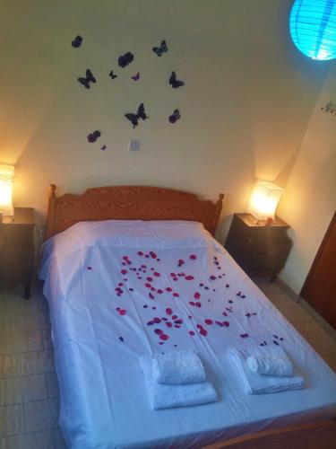 a bedroom with a bed with butterflies on the wall at 777 Beach Guesthouse in Paphos City