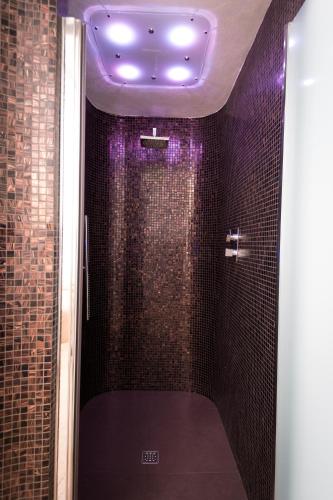 a bathroom with a shower with a purple ceiling at Hotel Miramonti in Sestola