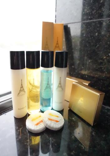 a group of three bottles sitting next to a box at Paris Suites Hotel in Queens
