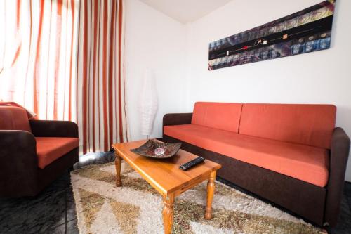 a living room with a couch and a coffee table at Apartamentos Jucar in Frontera