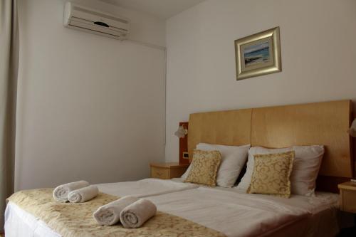 a bedroom with a bed with towels on it at Rooms Nadia3 in Baška