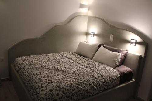 a bedroom with a large bed with two pillows at Amorgos Pearls in Katapola