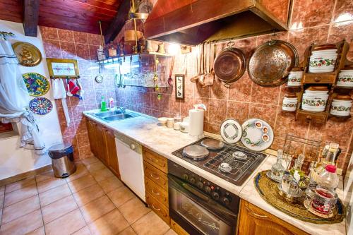 a kitchen with a sink and a stove top oven at Royal Antique Apartment in Split