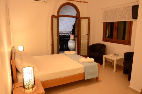 a small bedroom with a bed and a window at Natsios Studios in Gaios