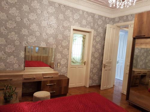 a bedroom with a bed and a mirror on the wall at House #1 in Kutaisi