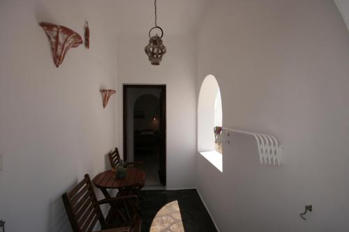 a room with a table and two chairs and a hallway at Pension Anna in Naousa