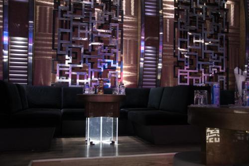 a lobby with couches and a chandelier at Hotel Cartoon Razgrad in Razgrad